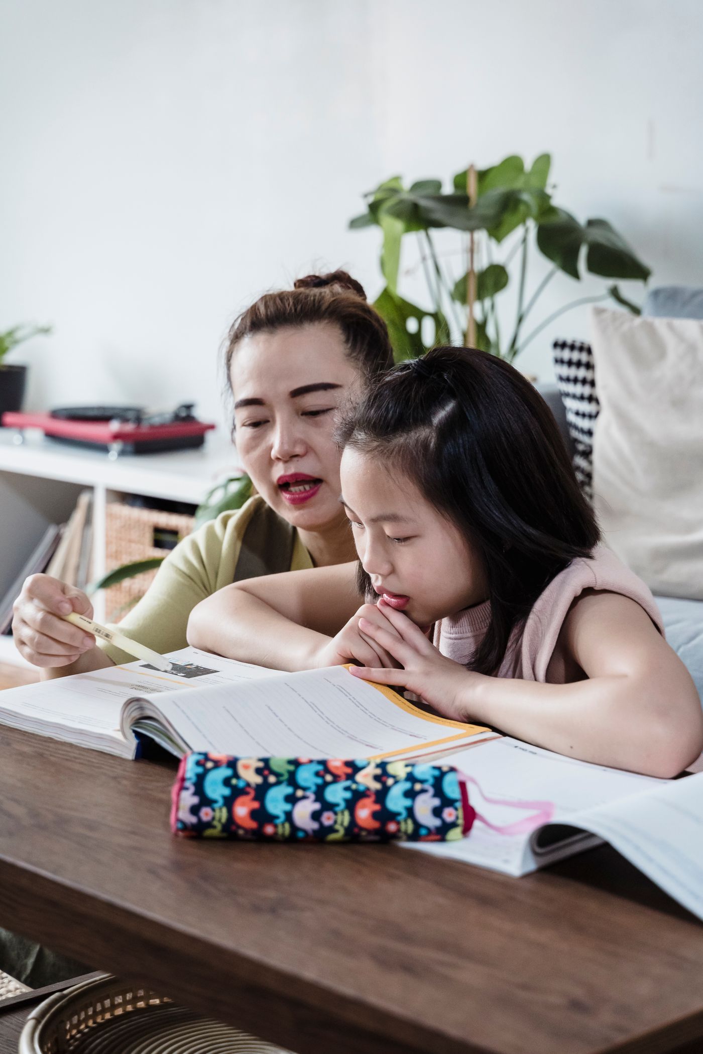 A parent helping a child with homework at home