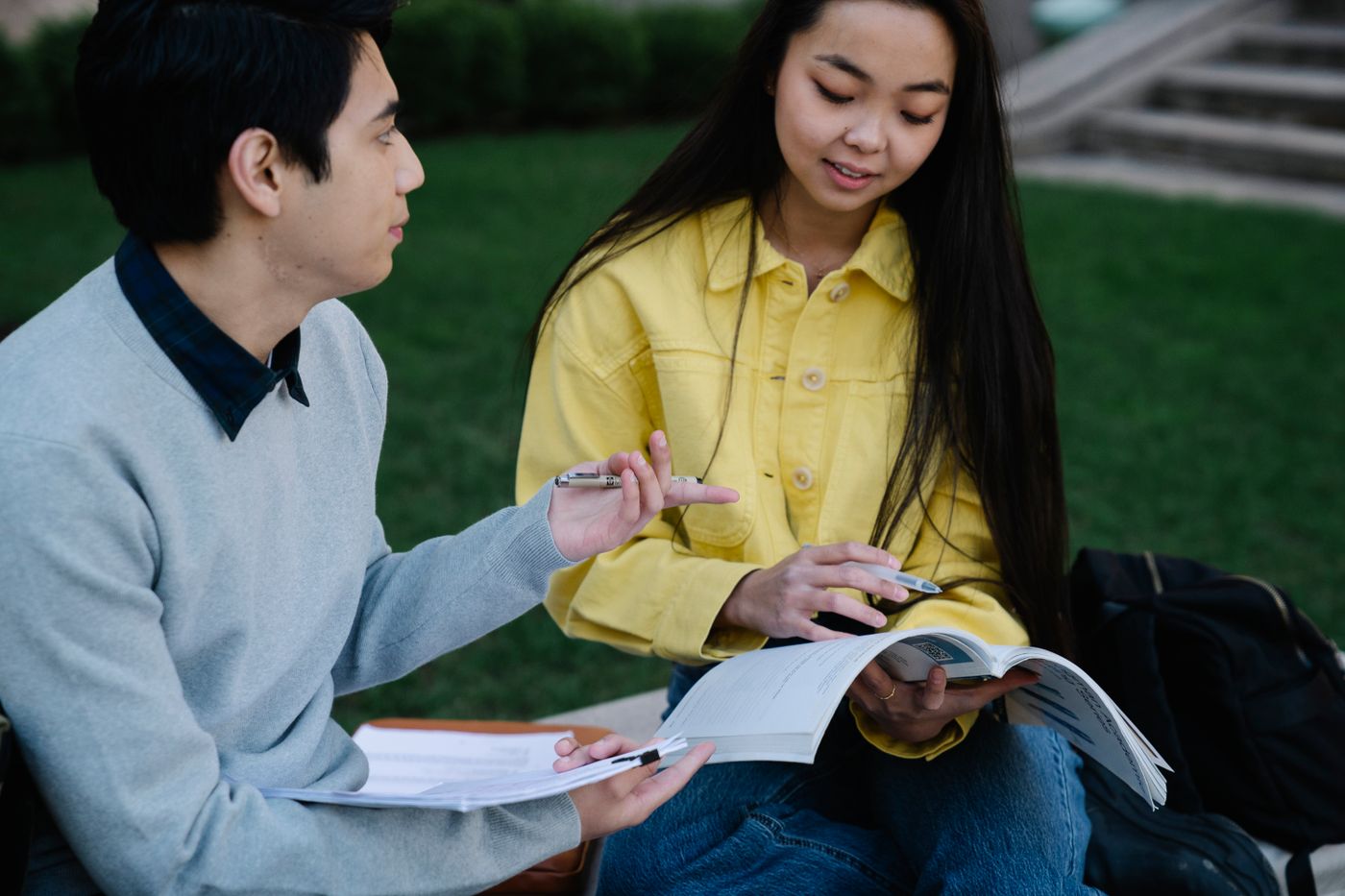 Two students reviewing together outdoors